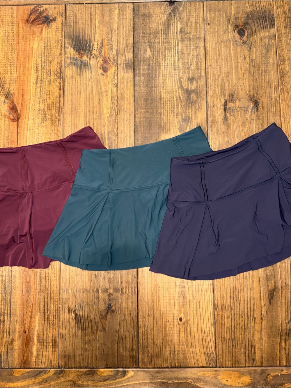 Three Lululemon Skorts in Maroon, Teal, and Navy